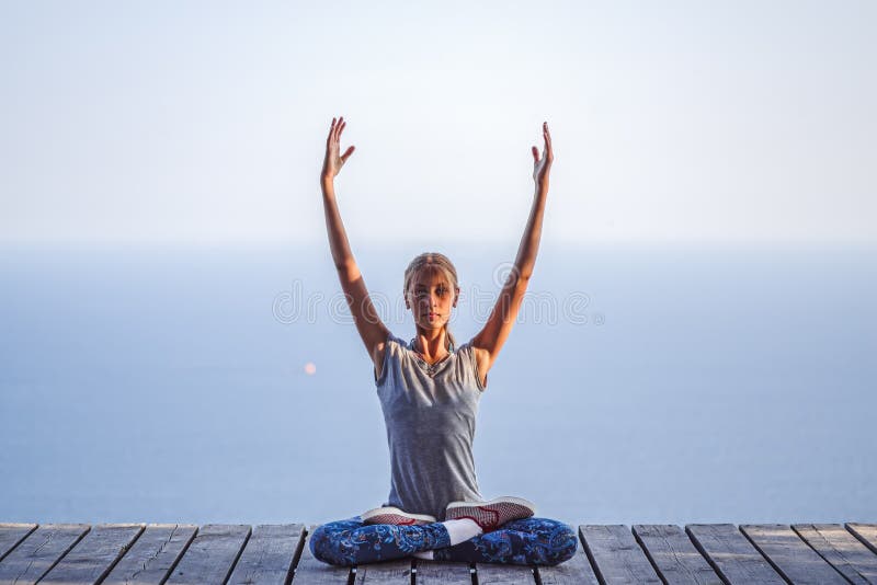 Baby girl in Lotus pose on the background of the sea royalty free stock photography Baby girl in Lotus pose on the background of the sea royalty free stock photography