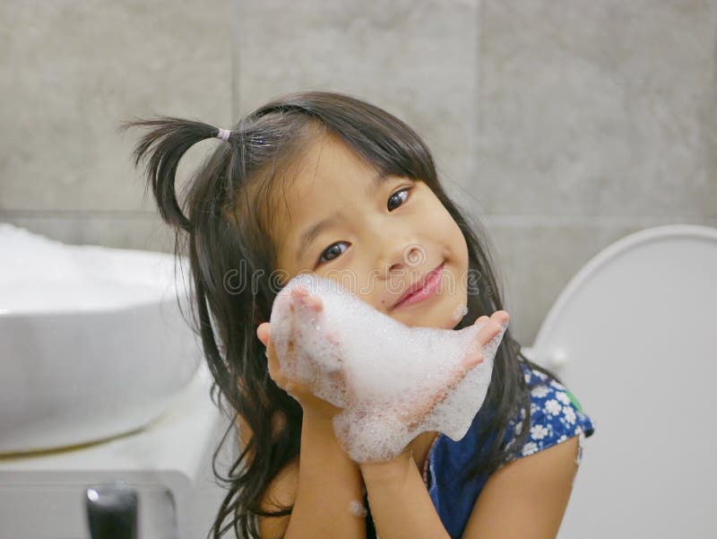 Little Baby Girl, 4 Years Old, Enjoys Making Soap Foam / Bubbles