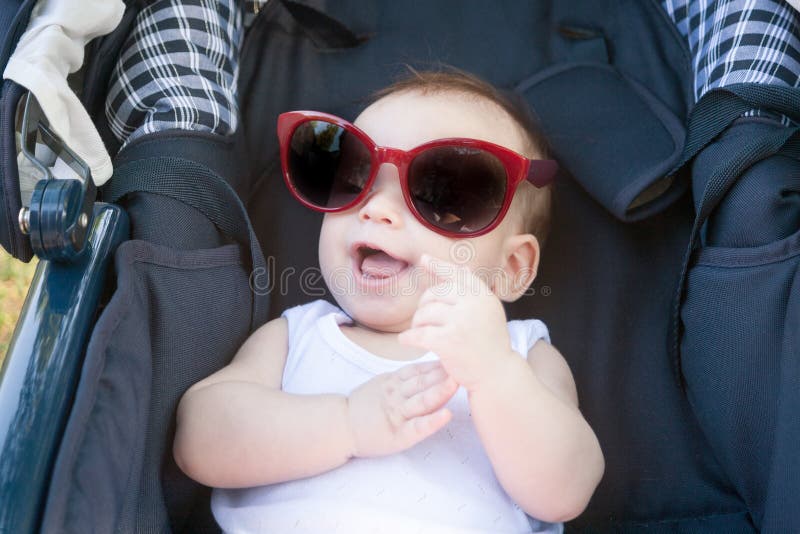 Little Baby In A Stroller In Funny Big Sunglasses Funny Baby Smiling