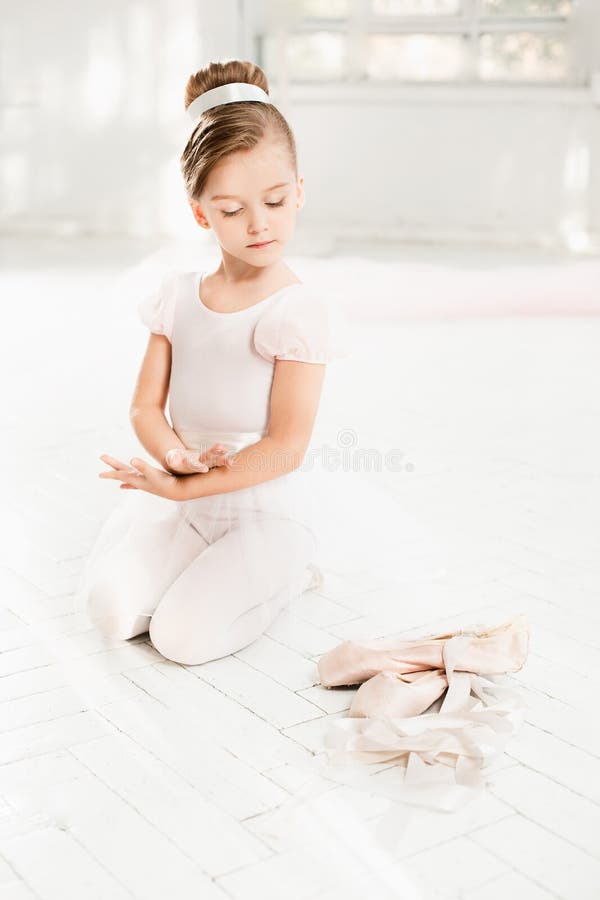 The little balerina in white tutu in class at the ballet school royalty free stock photo The little balerina in white tutu in class at the ballet school royalty free stock photo