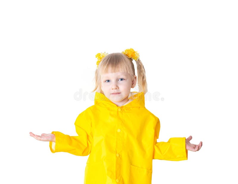 Little beautiful girl with pigtails 3 years old in a yellow raincoat on a white background, isolate. Bad weather concept in autumn