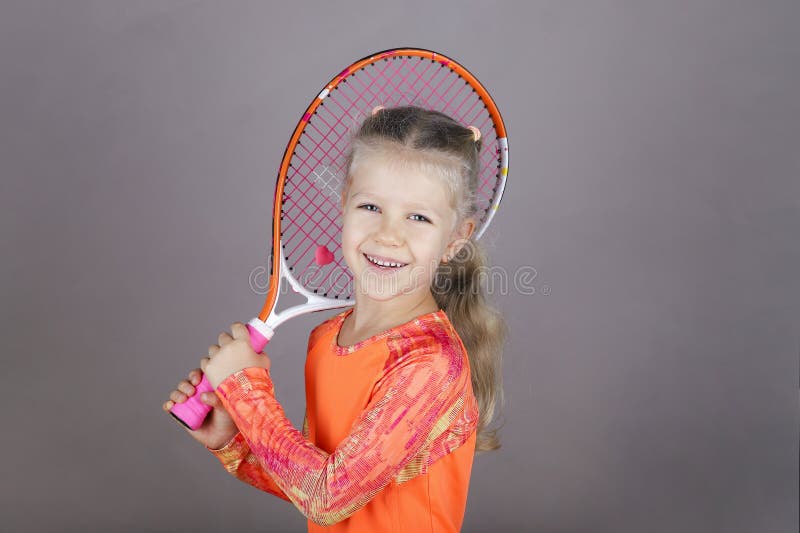 Little beautiful girl with a tennis racket stock photo Little beautiful girl with a tennis racket stock photo