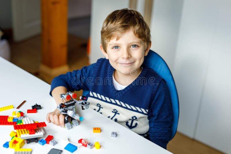 Little blond kid boy playing with lots of colorful plastic blocks. royalty free stock photo Little blond kid boy playing with lots of colorful plastic blocks. royalty free stock photo