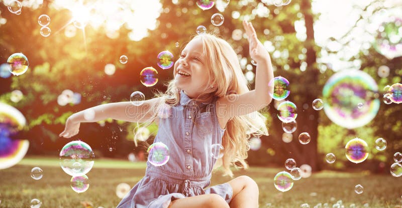 Little blond girl among lots of flying bubbles stock images Little blond girl among lots of flying bubbles stock images