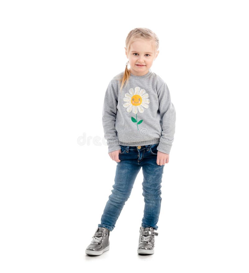 Little blonde child smiling awkwardly, wearing blue jeans and gray sweatshirt, isolated on white background. Little blonde child smiling awkwardly, wearing blue jeans and gray sweatshirt, isolated on white background