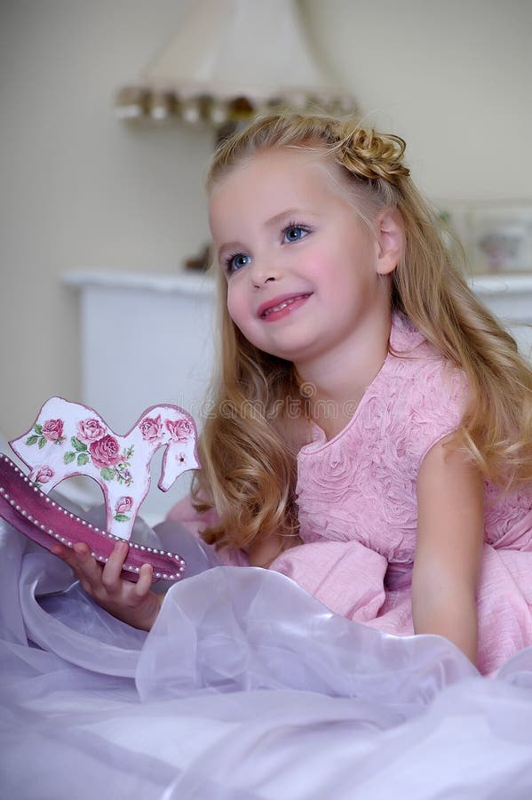 Little Blonde Girl In A Pink Dress With Curls And A Beautiful Hairstyle Stock Image Image Of 