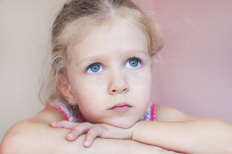 Little blonde hair girl with sad eyes looking up royalty free stock image Little blonde hair girl with sad eyes looking up royalty free stock image
