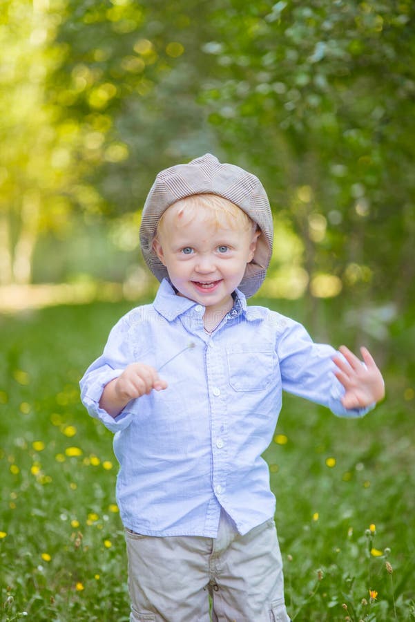 Little Boy with Blond Hair in a Cap and Blue Shirt in Summer Stock ...