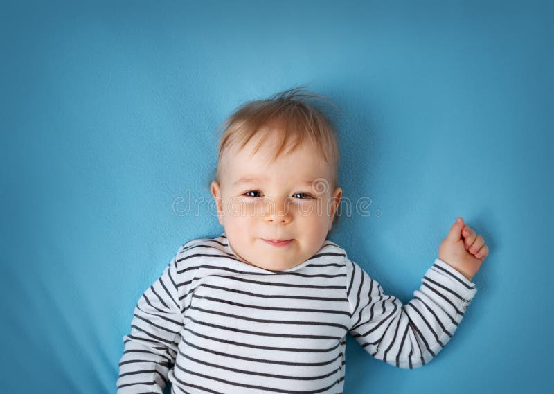 Little Boy on Blue Blanket Background Stock Photo Image of eyes, hand