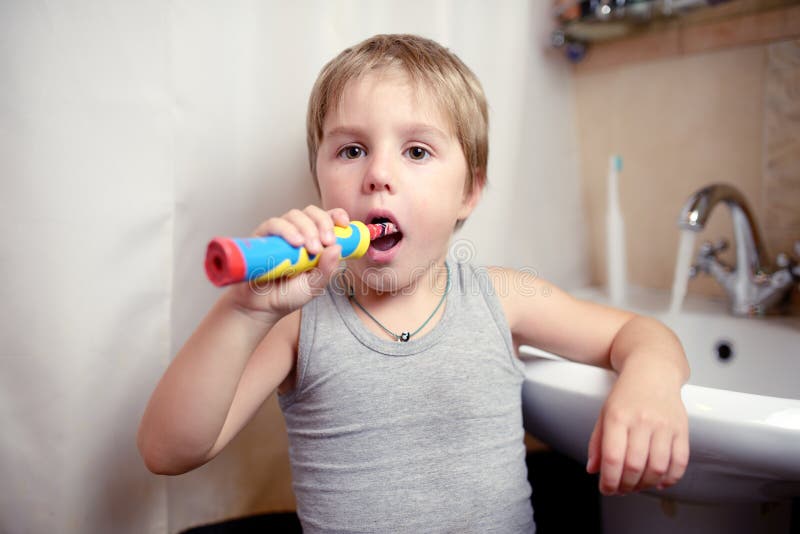 Little Boy Brushing Teeth in Bath with Electric Brush Stock Image