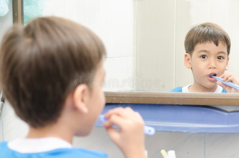 Little Boy Brushing Teeth Looking on Mirror Dental Heathcare Stock
