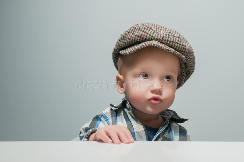 Little Boy in a Cap Sits at the Table Stock Photo - Image of colors ...