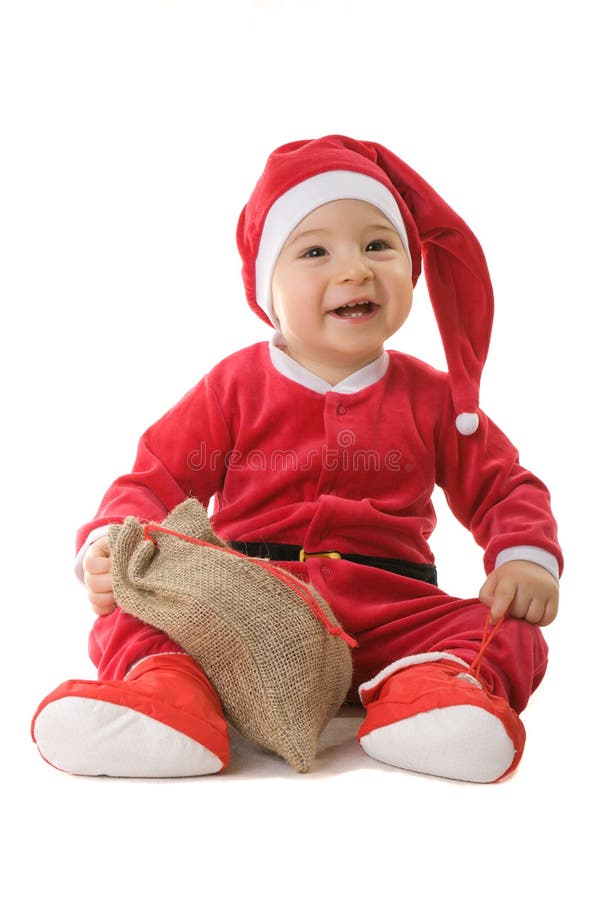 A little boy dressed as Santa Claus