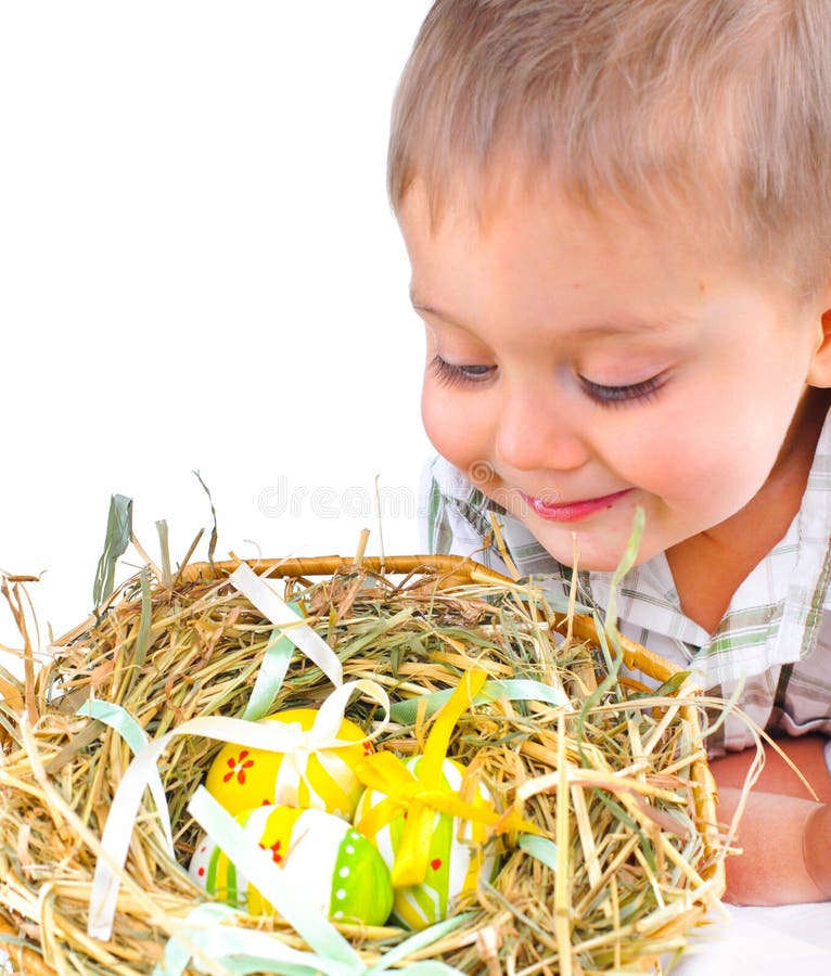 Little boy with easter eggs in basket