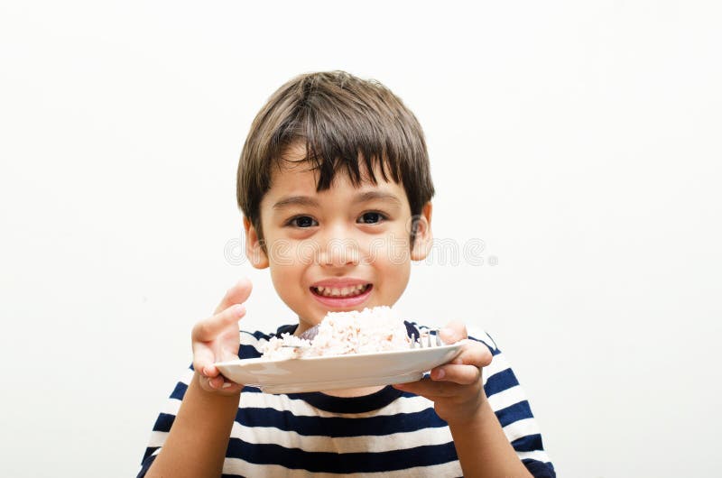 Little boy eating rice happy face