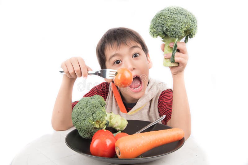 Little boy eating vegetable