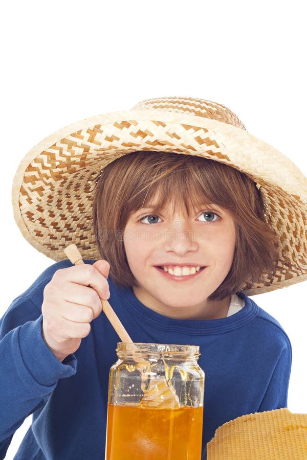 Little boy eats honey