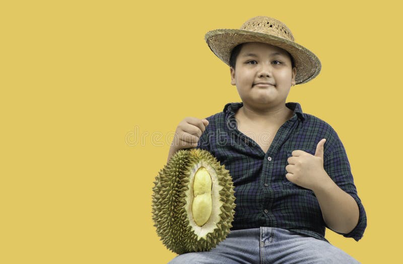 Little boy farmer holding Mon Thong Durian isolated stock photo