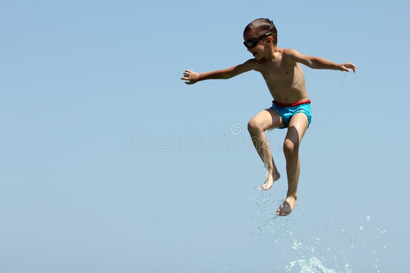 Little boy and father play in sea