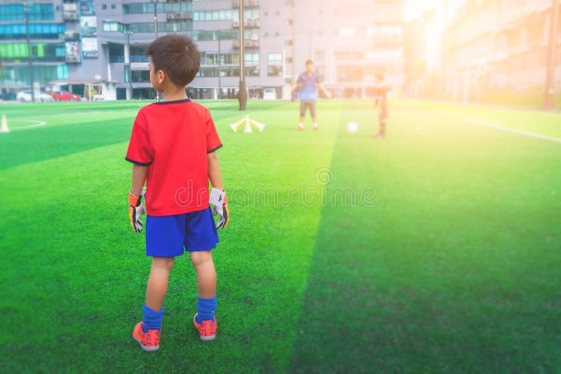 Little boy with goalie gloves standing on a training field stock photography Little boy with goalie gloves standing on a training field stock photography