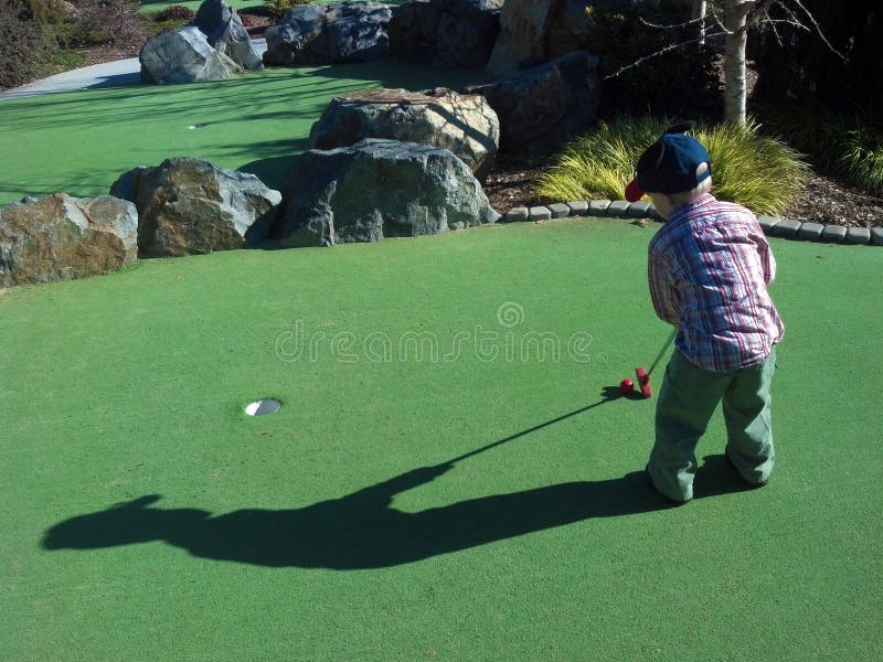 Little boy golfing