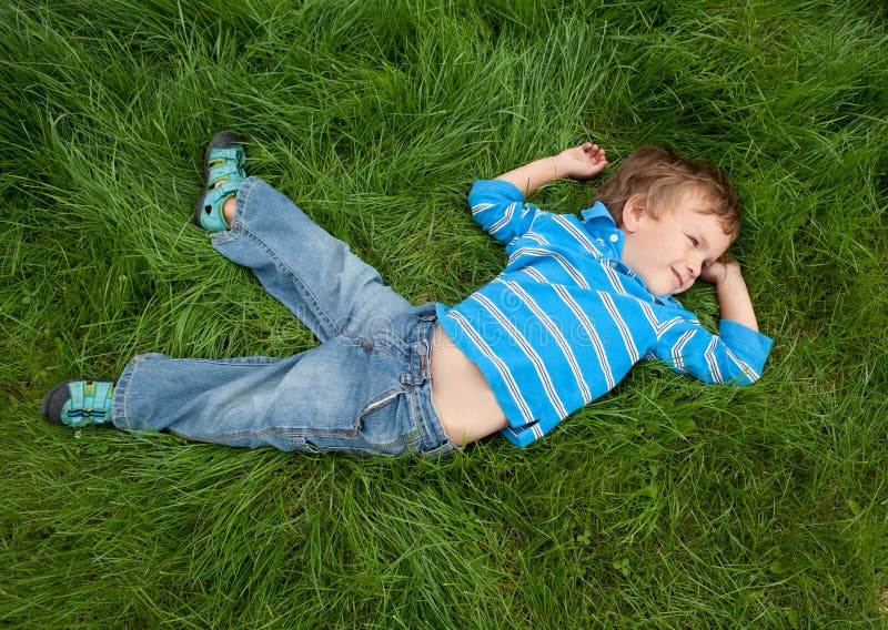 Little boy on grass royalty free stock images.