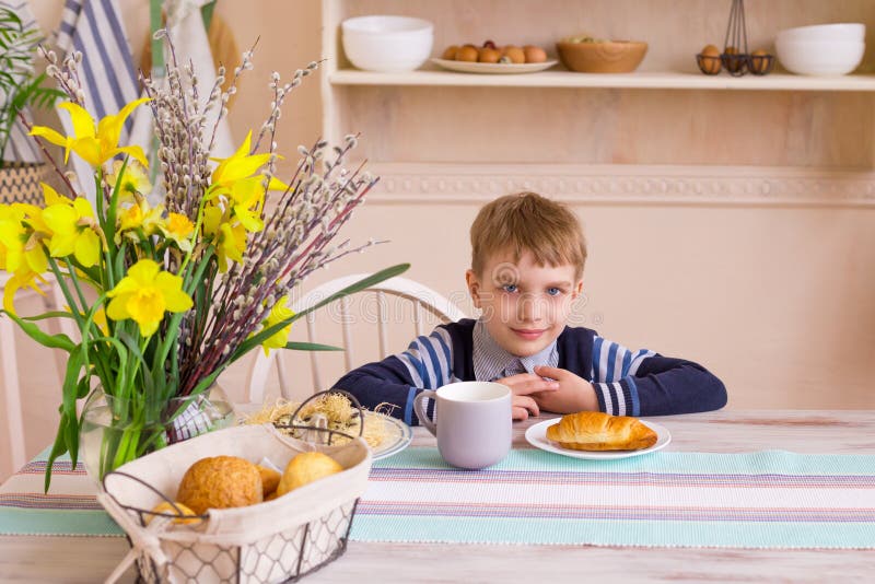 Little boy having breakfast in the modern kitchen. stock image Little boy having breakfast in the modern kitchen. stock image