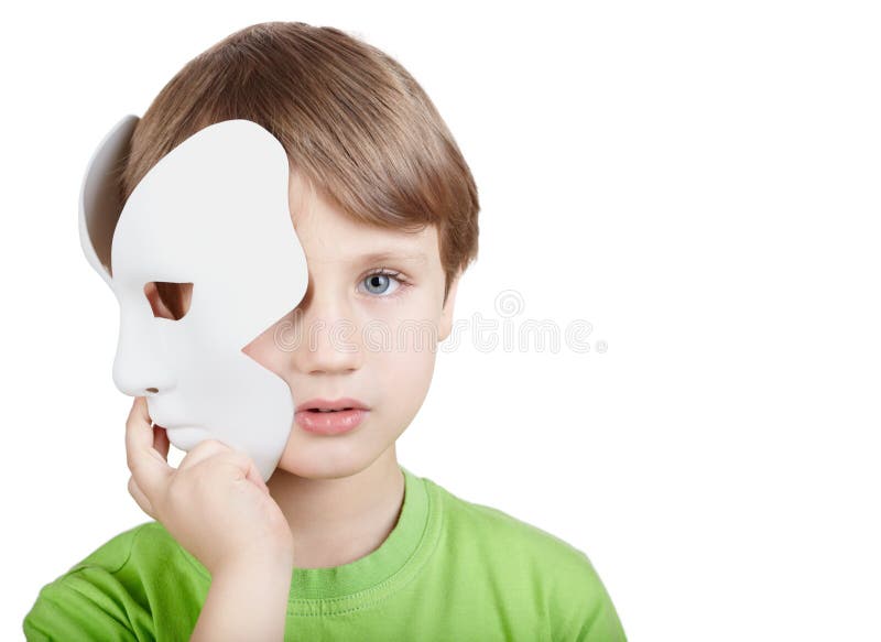Little boy hides half of face behind mask