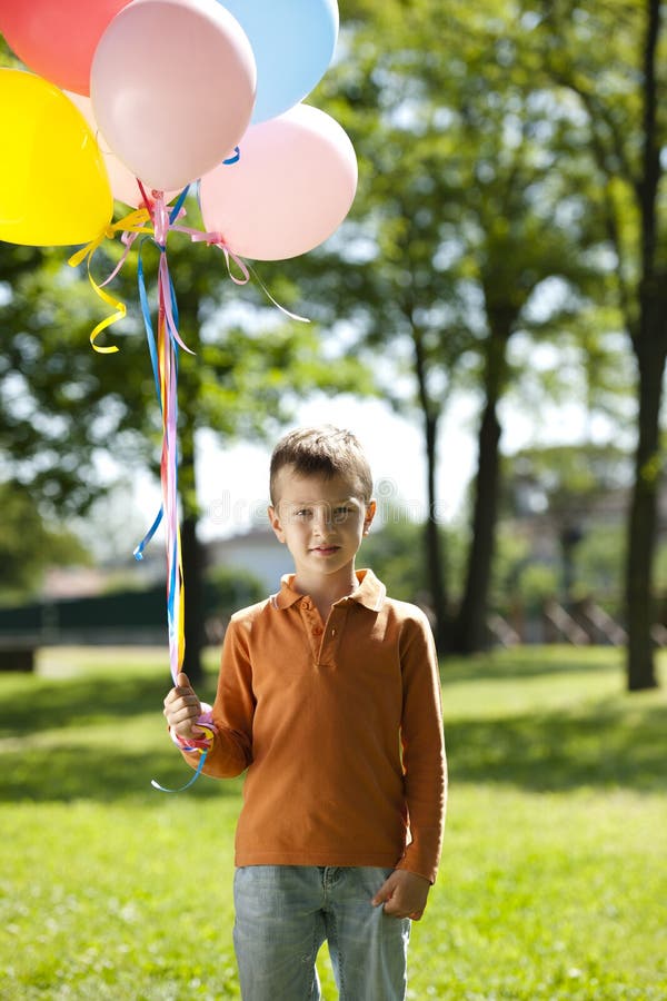 Little Boy Holding Balloons Stock Photo Image of standing, camera