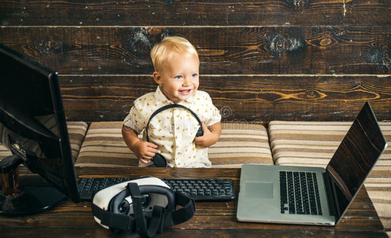 Little boy with laptop computer in room. Laptop user learn new technology. Experience IT