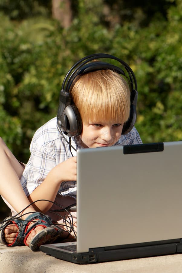 Little boy with laptop in park