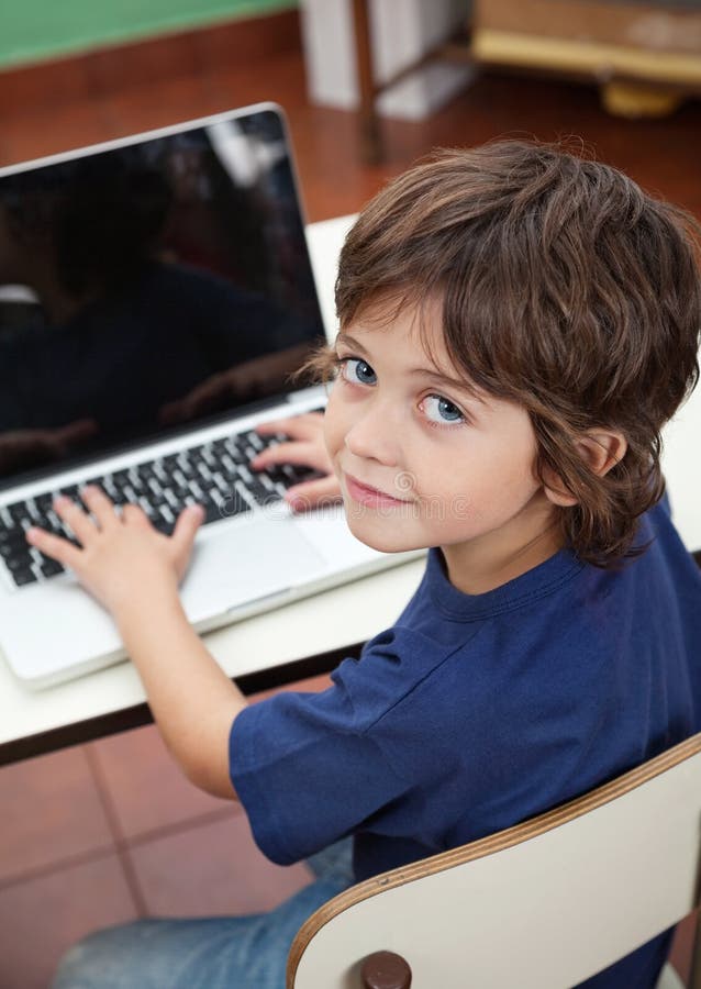 Little Boy With Laptop In Preschool