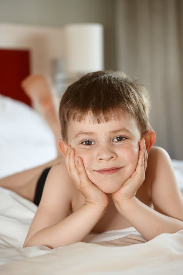 Little boy laying on bed stock image. Image of indoors 20170211