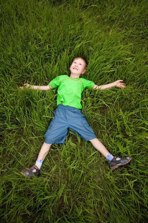 Little boy laying on the grass