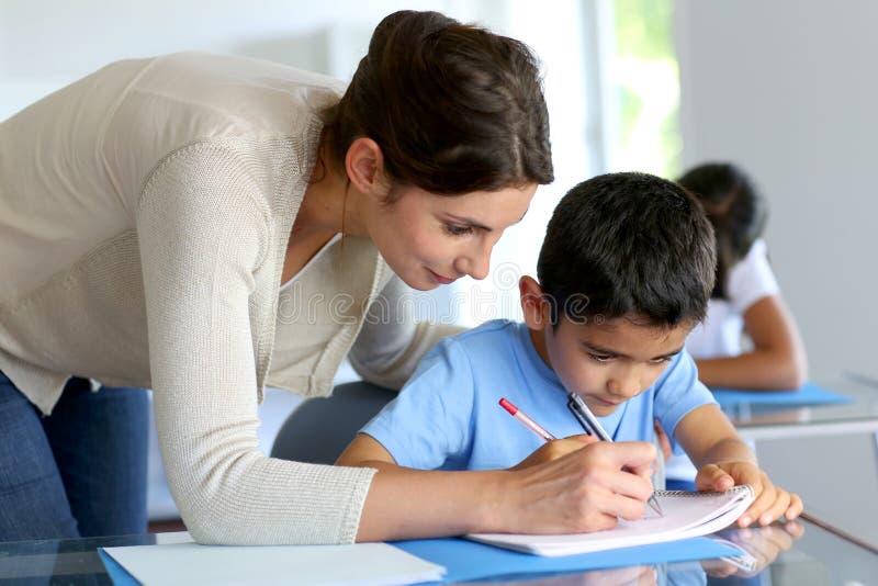 Little boy learning how to write with teacher royalty free stock photography Little boy learning how to write with teacher royalty free stock photography