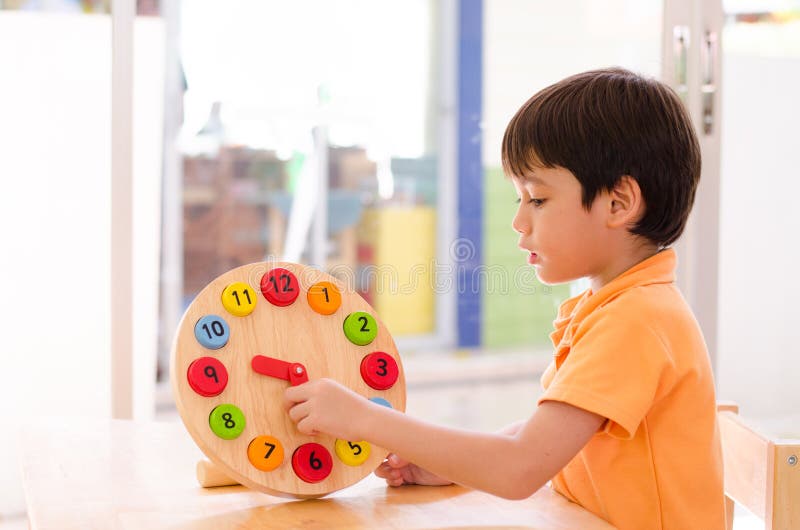 Little boy learning time with clock toy of montessori educationa