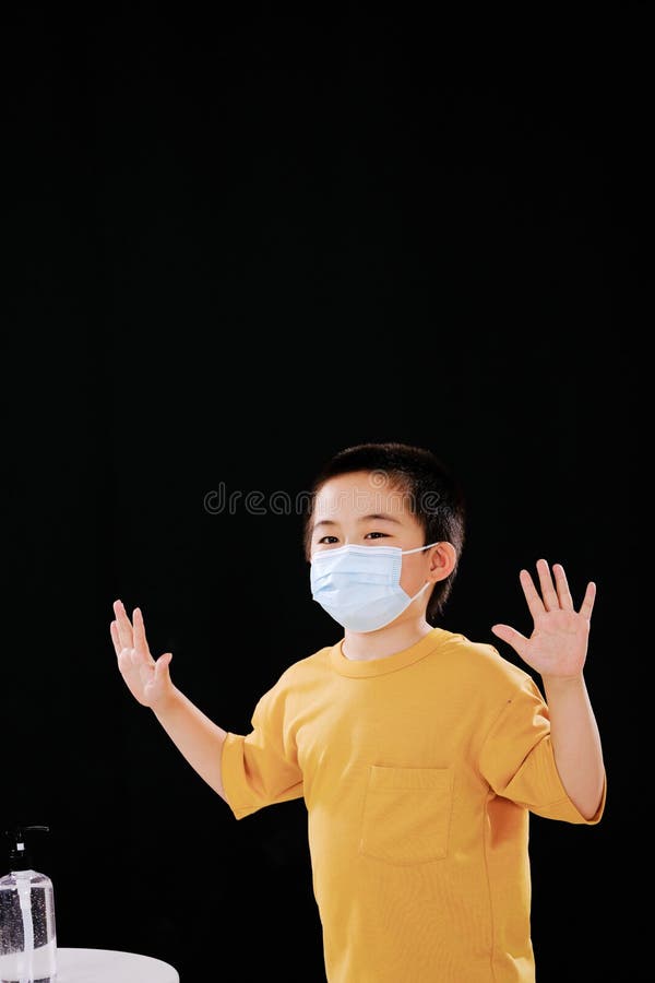 The Little Boy with Mask Shows His Hands after Using Hand Sanitizer