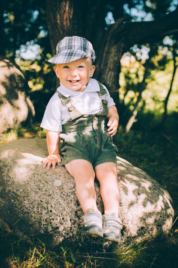 The Little Boy in Overalls and a Cap Stock Image Image of forest