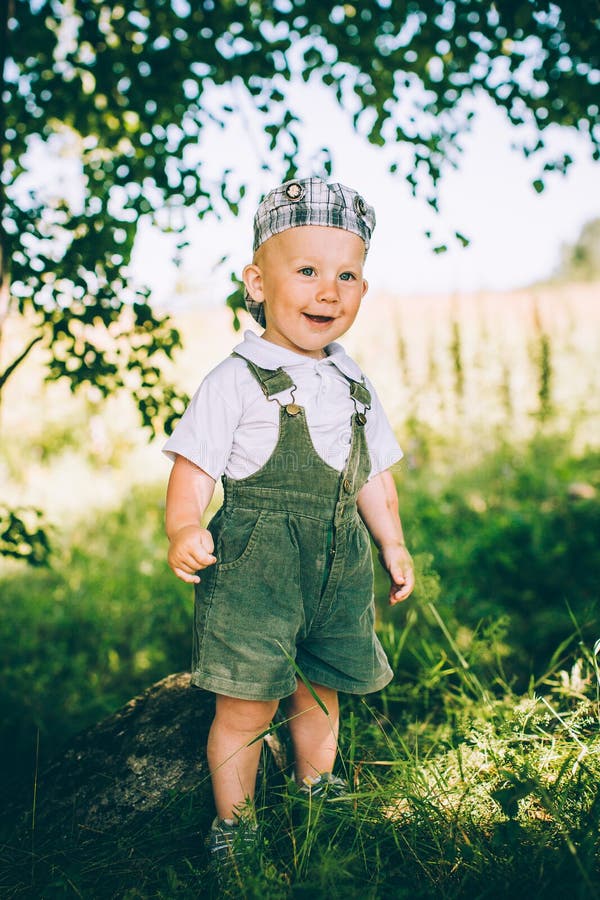 The Little Boy in Overalls and a Cap Stock Image Image of lifestyle