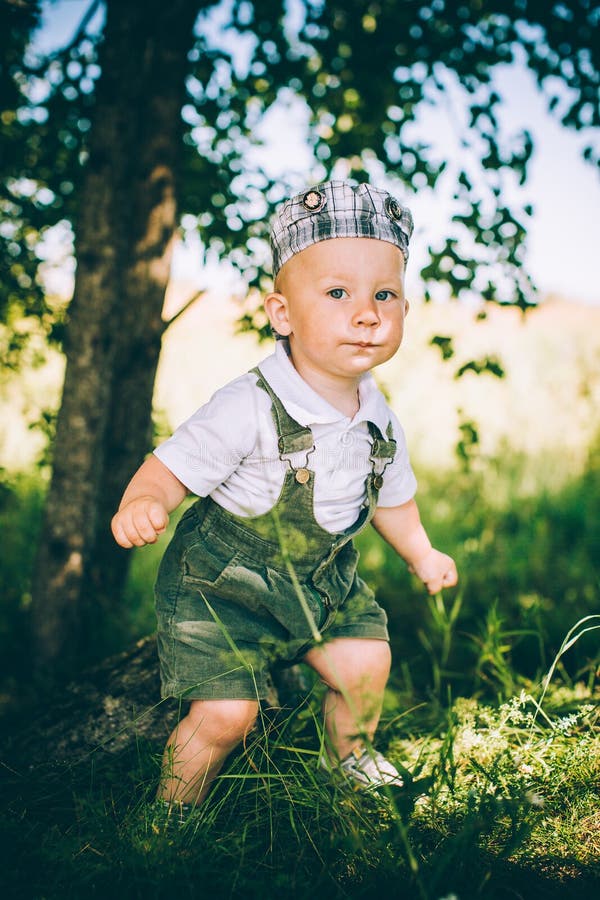 The Little Boy in Overalls and a Cap Stock Image Image of casual