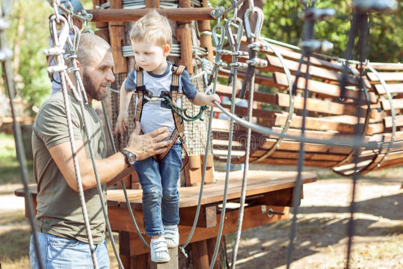 Little cute boy overcomes an obstacle stock photos Little cute boy overcomes an obstacle stock photos