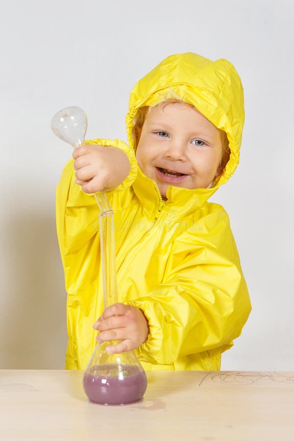 Little boy play chemists game at home