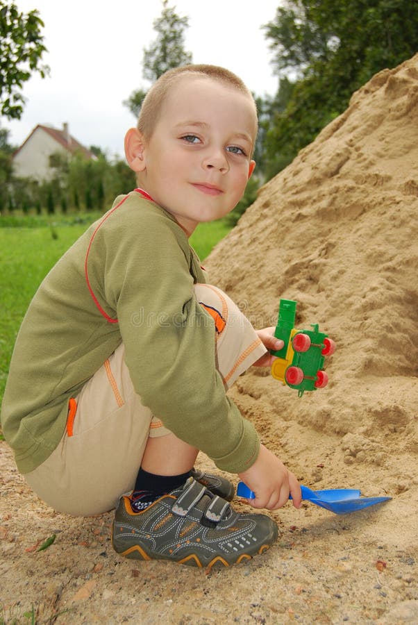 Little boy play with sand