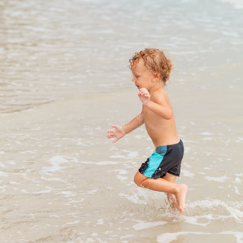 Little boy playing on the beach.