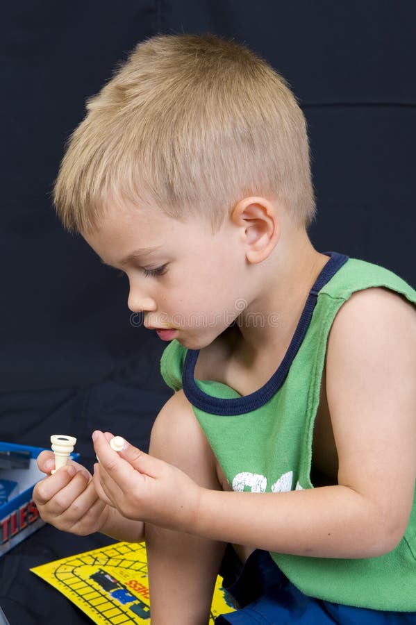 Little boy playing on black background