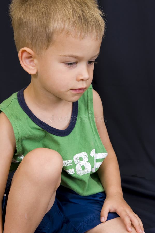 Little boy playing on black background