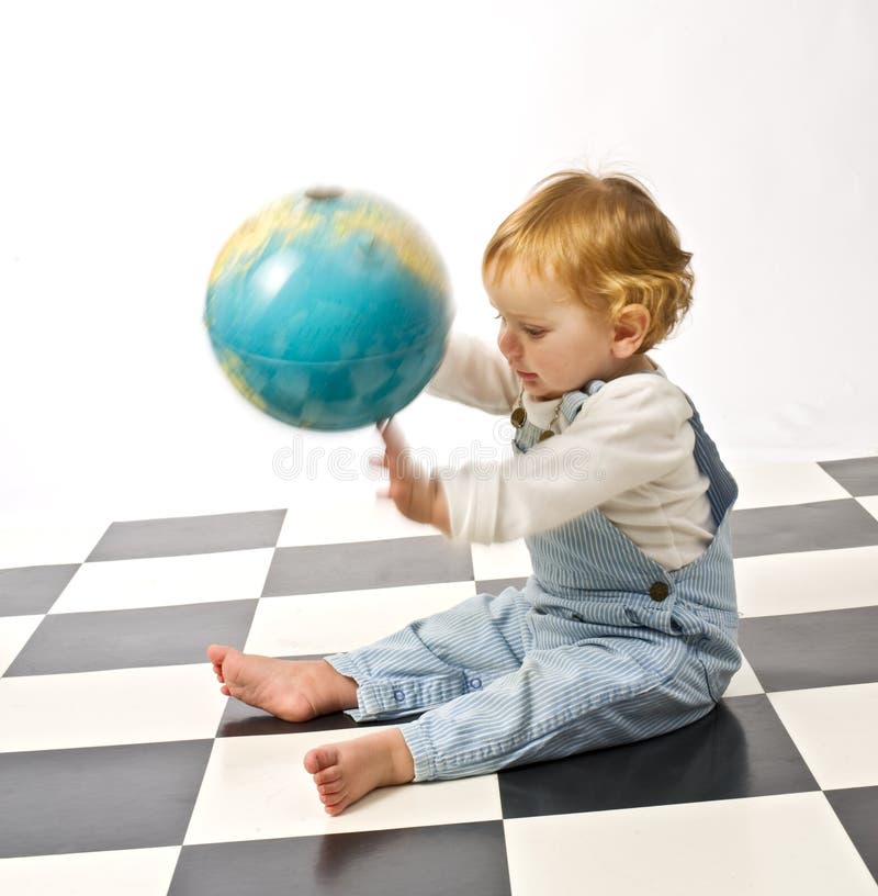 Little boy playing with a globe