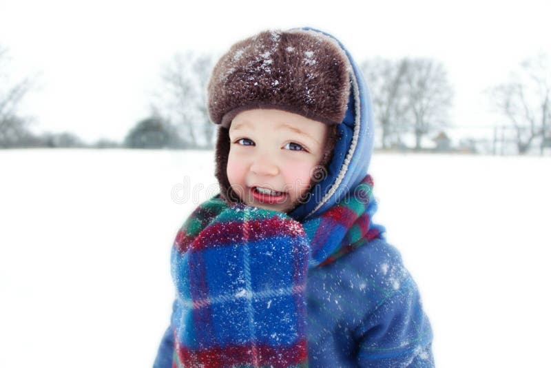 Little boy playing in snow