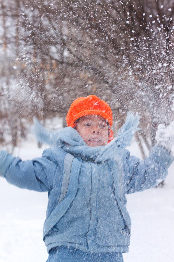 Little boy playing snowballs