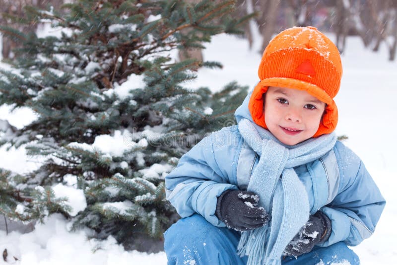 Little boy playing snowballs